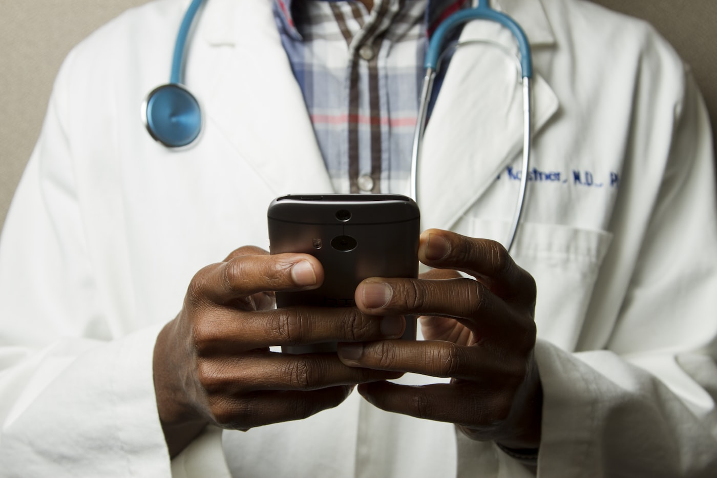 Clinician using a healthcare app on a phone